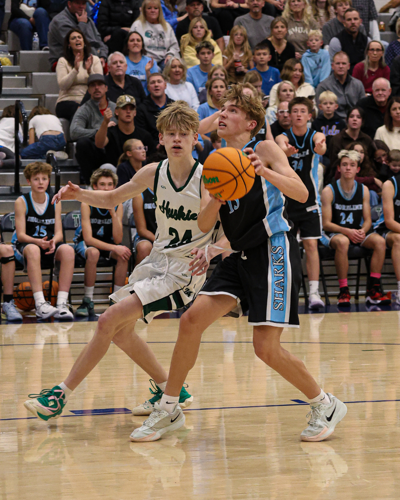 A Shoreline Junior High player looks up at the rim while holding the basketball at the Davis School District Boys Basketball Championship Game. 
