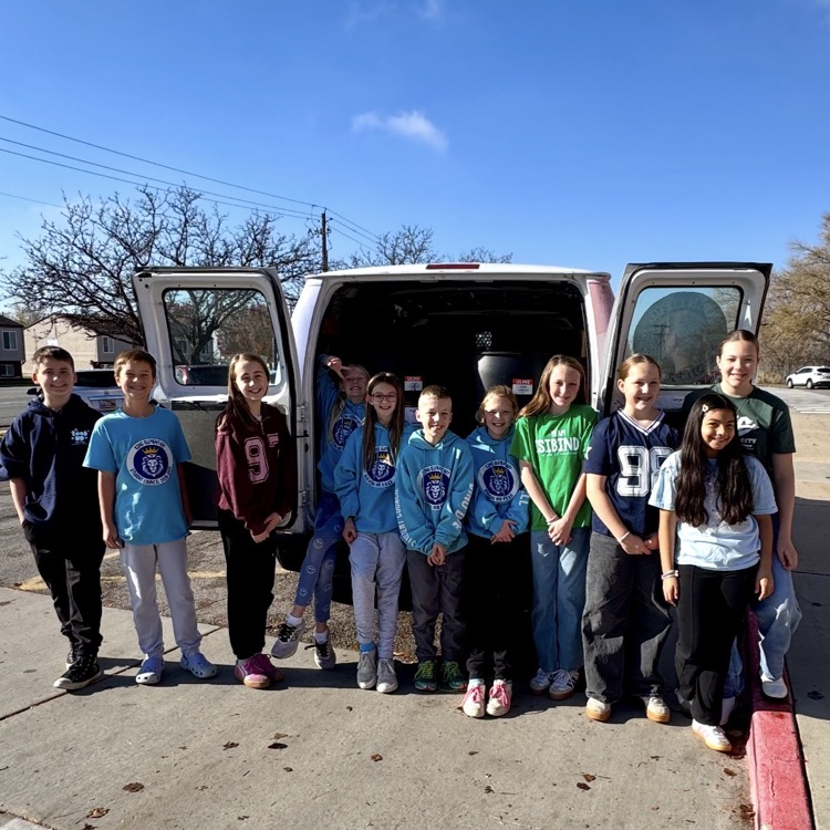 student council members helping load up the van with all the food drive donations