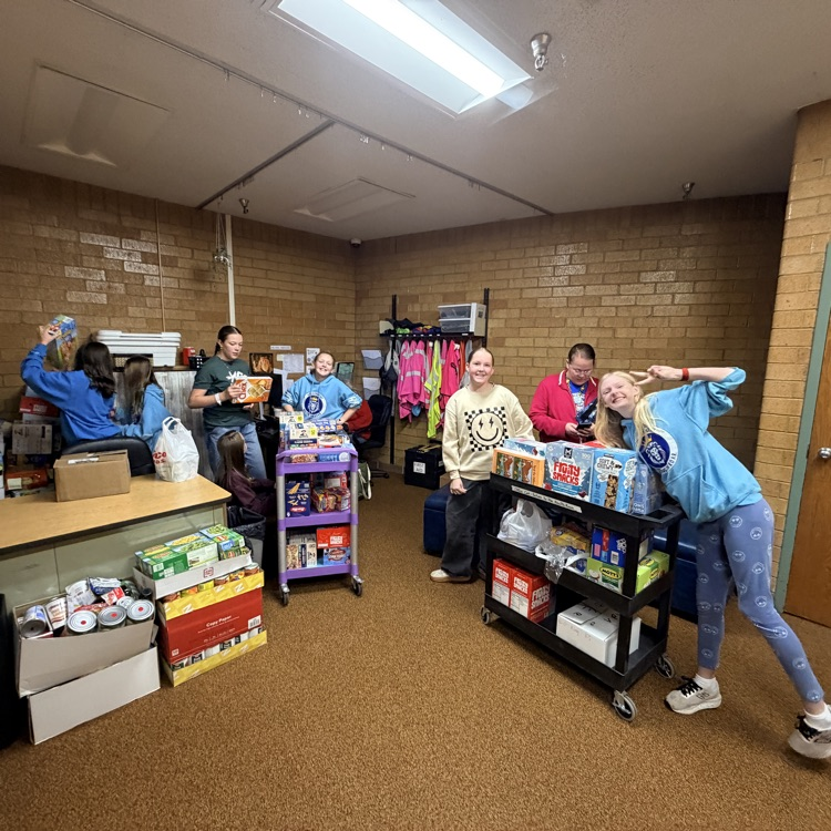 student council members helping load up the van with all the food drive donations