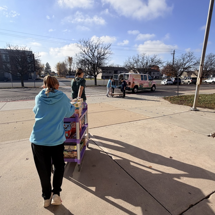 student council members helping load up the van with all the food drive donations