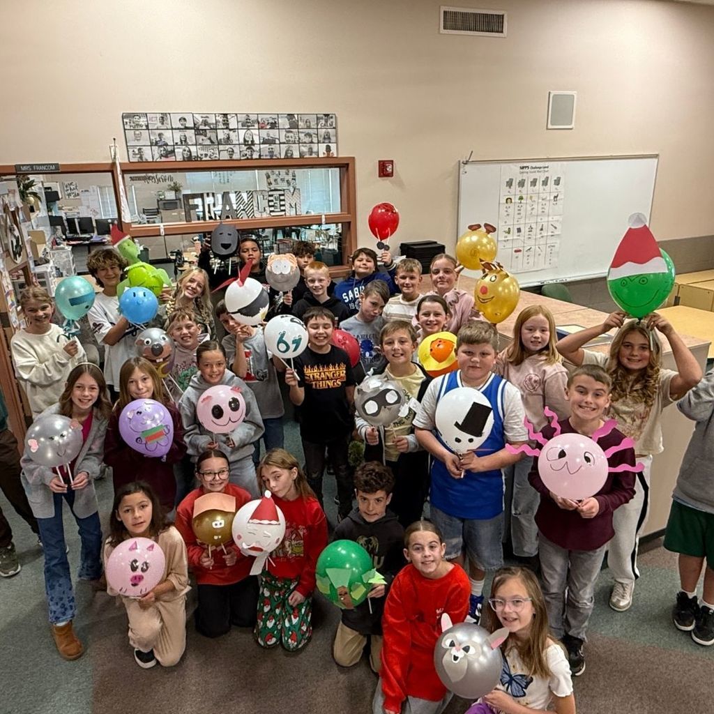 Students holding Balloons they decorated for Thanksgiving.