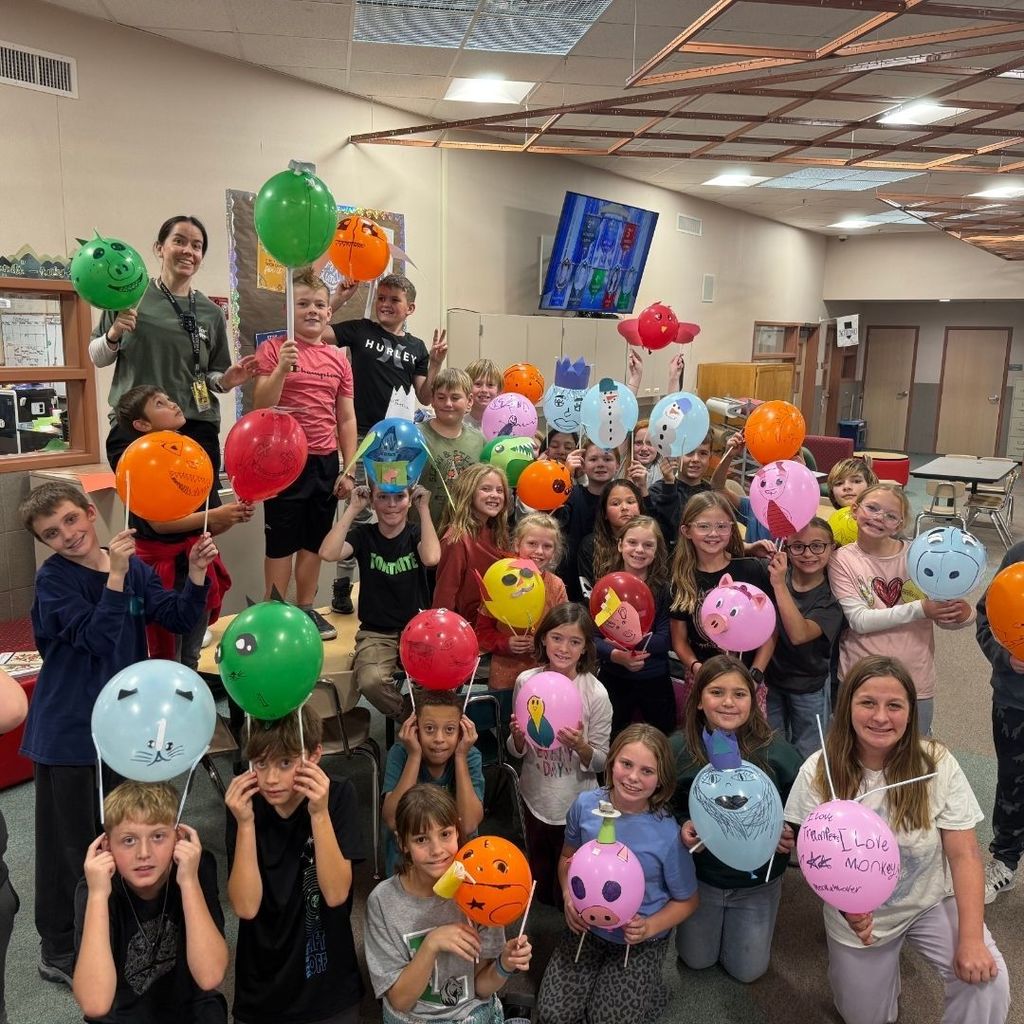 Students holding Balloons they decorated for Thanksgiving.