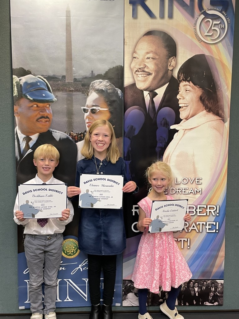 Students with MLK background holding certificates for participation