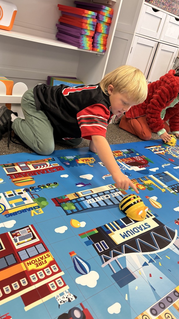 young boy pressing a button on a robotic bee
