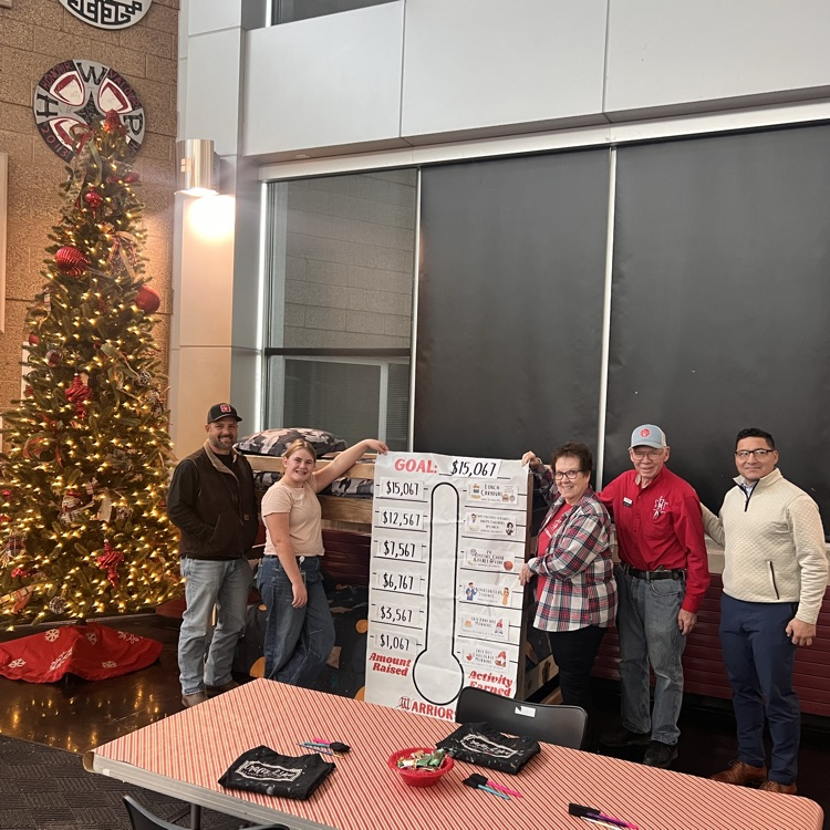 bed and Christmas tree people standing