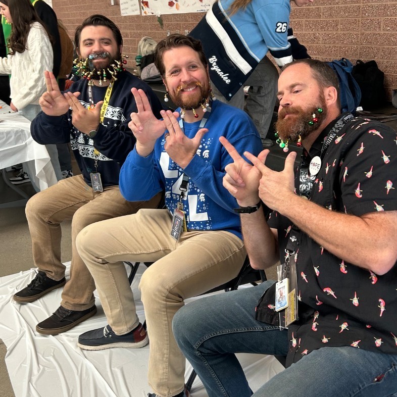 Mr. Pendergast, Mr. Gilman, and Mr. Bell all posing with their beard decorations