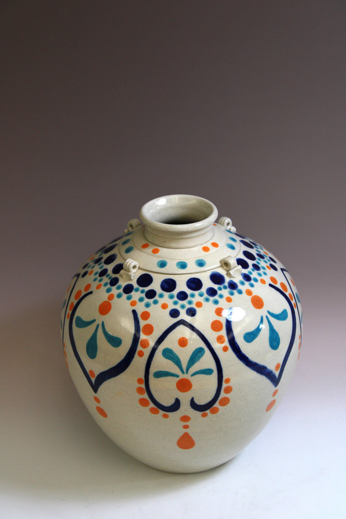 A student created orange and blue pot. 