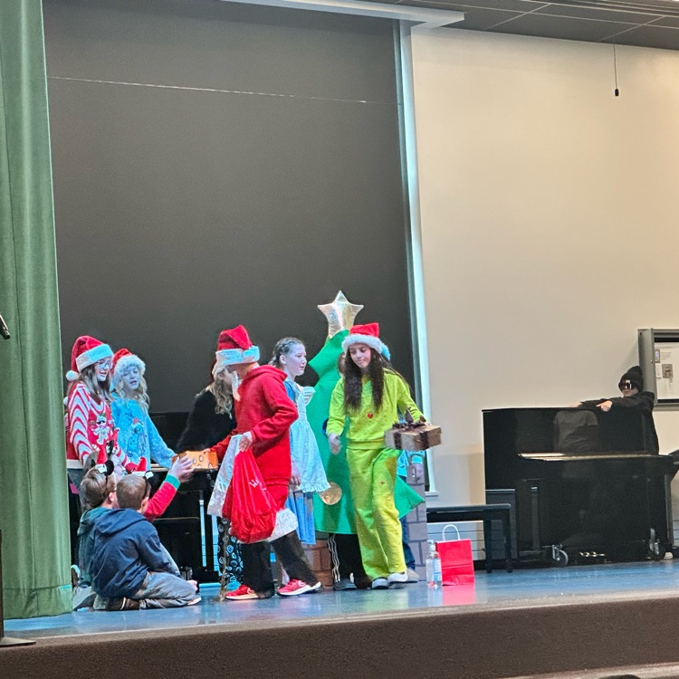 students in Christmas costumes on stage
