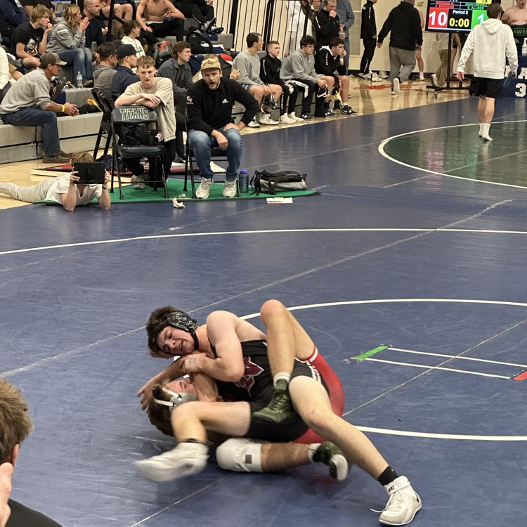 boys wrestling on a mat