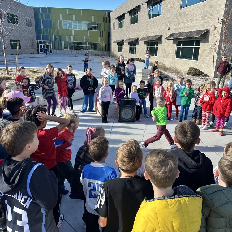 group of students in a circle with boy in middle