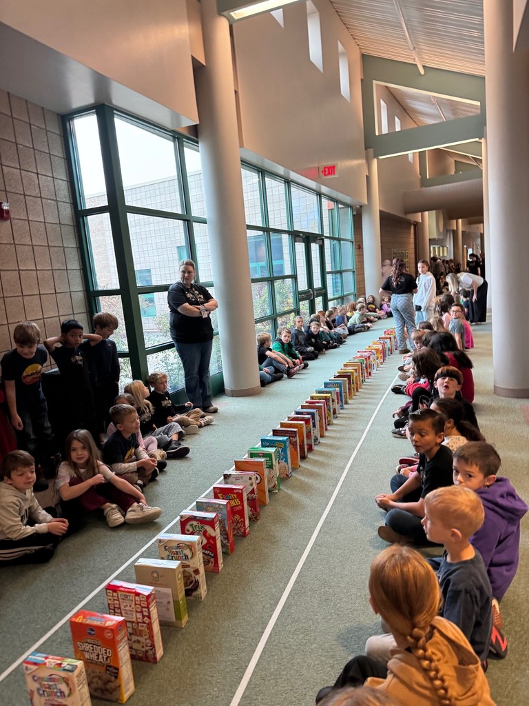 students sitting in the hallway watching cereal boxes tumble down the hallway