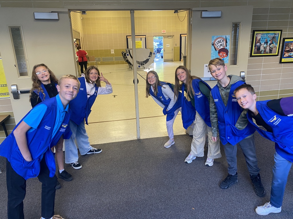 A photo of student council outside of the gym creating a welcoming tunnel