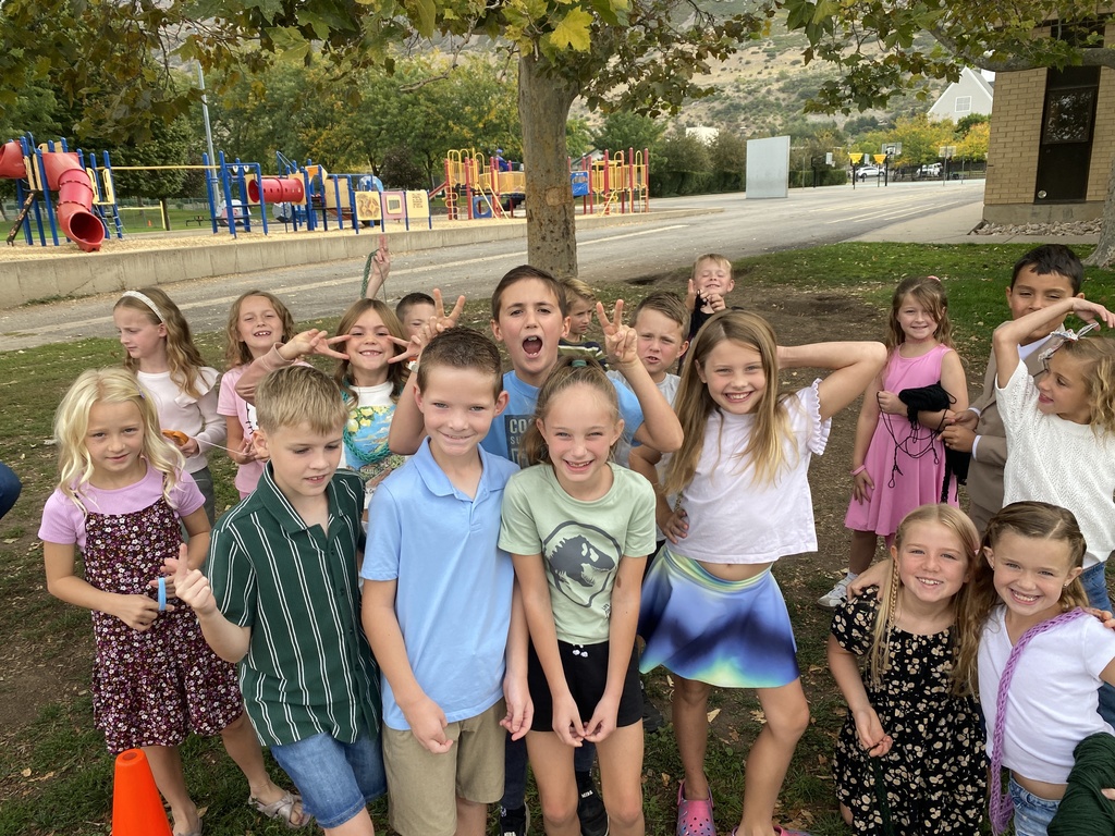 A photo of a group of kids all pulling silly faces.