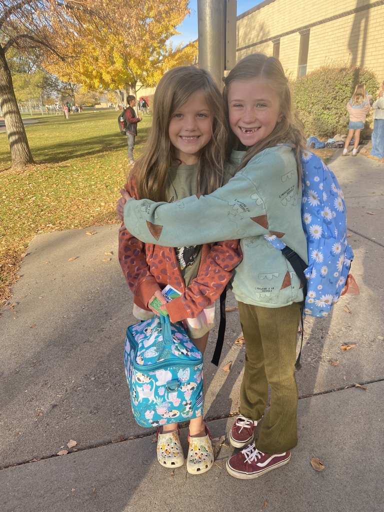 a photo of two young girls hugging with big smiles