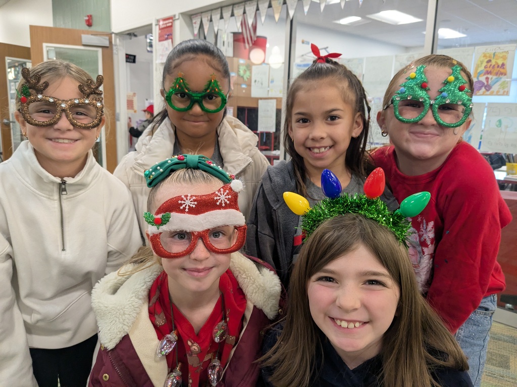 Group of 6 students all wearing various Christmas glasses and headpieces. 