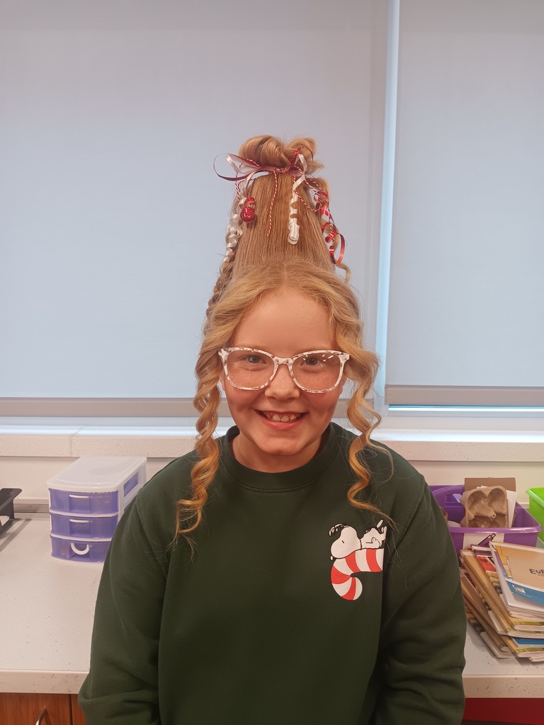 Student with crazy hair decorated with red ribbons. 