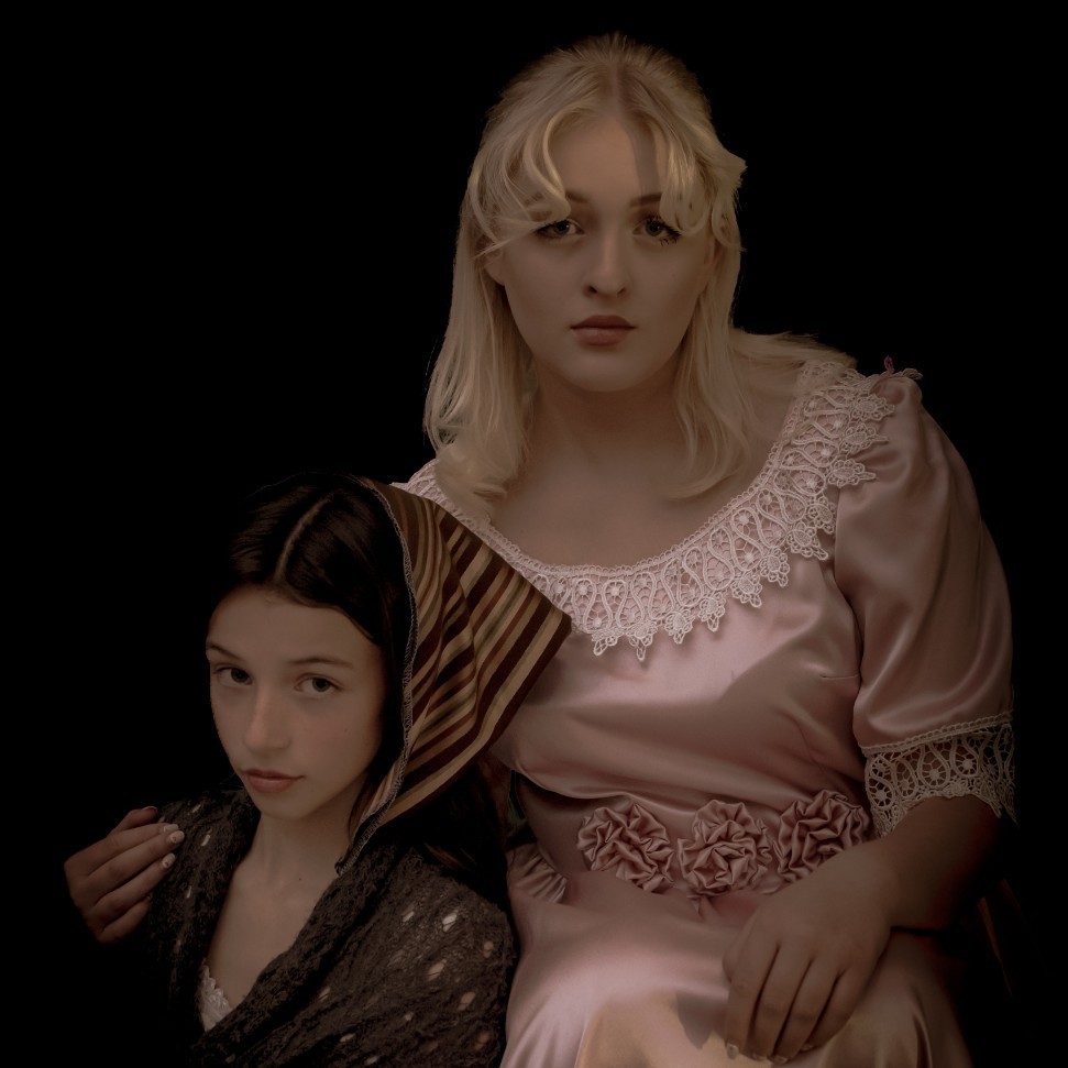 2 female students posing for a picture in Les Mis costumes