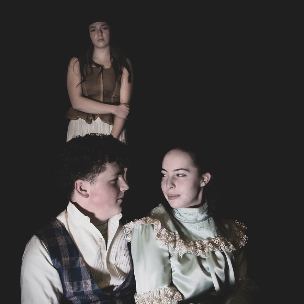 Three students posing for pictures in their Les Mis costumes