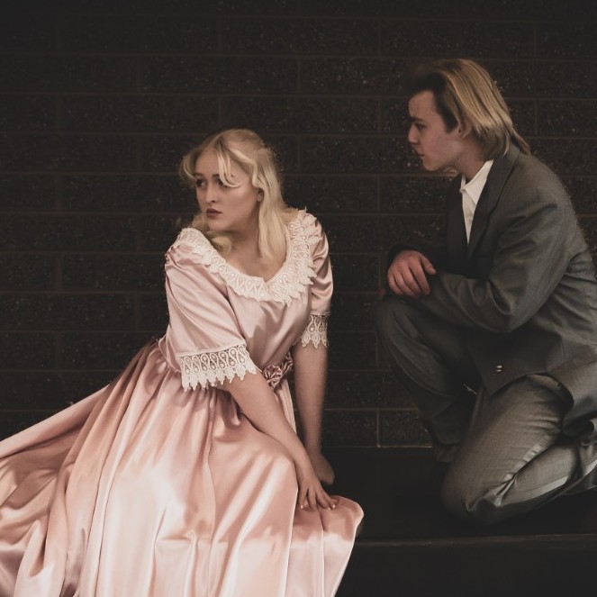 A male and female student dressed in Les Mis costumes