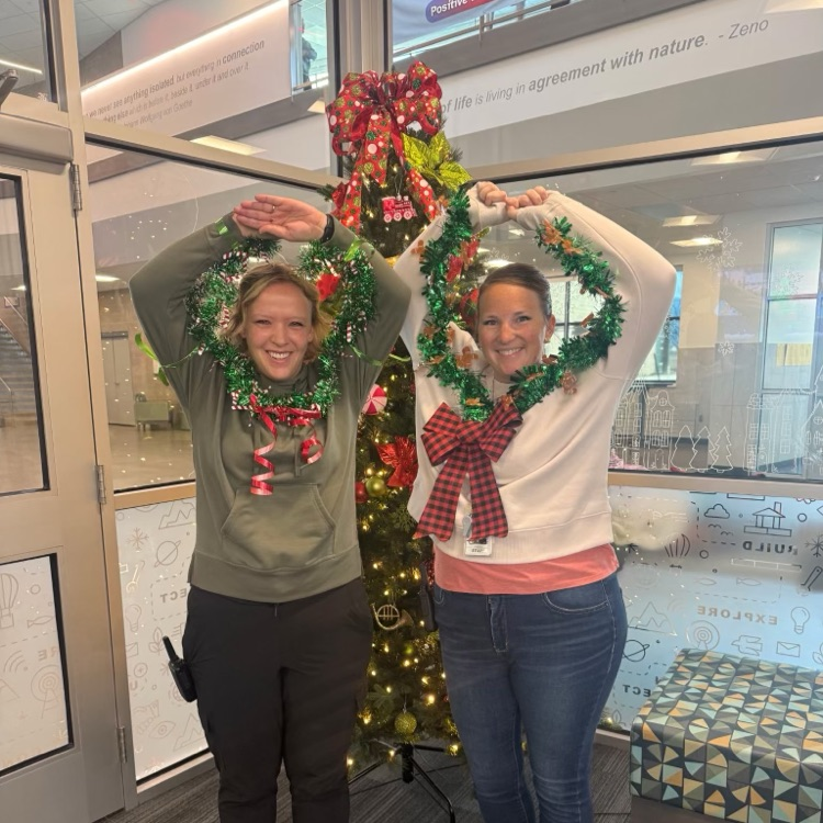 Two staff dressed as wreaths