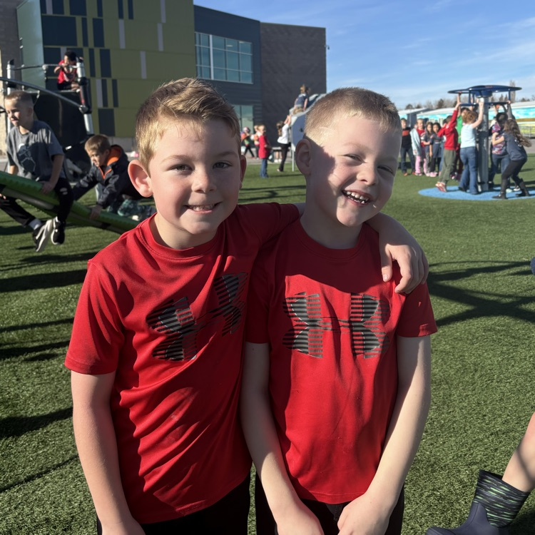 two boys with matching red athletic shirts