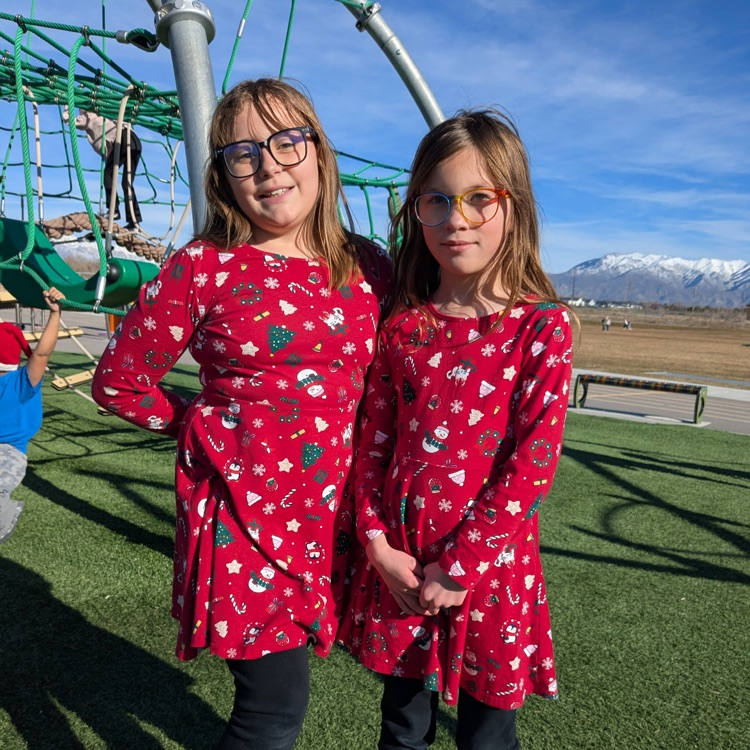 two students in matching red chirstmas dresses