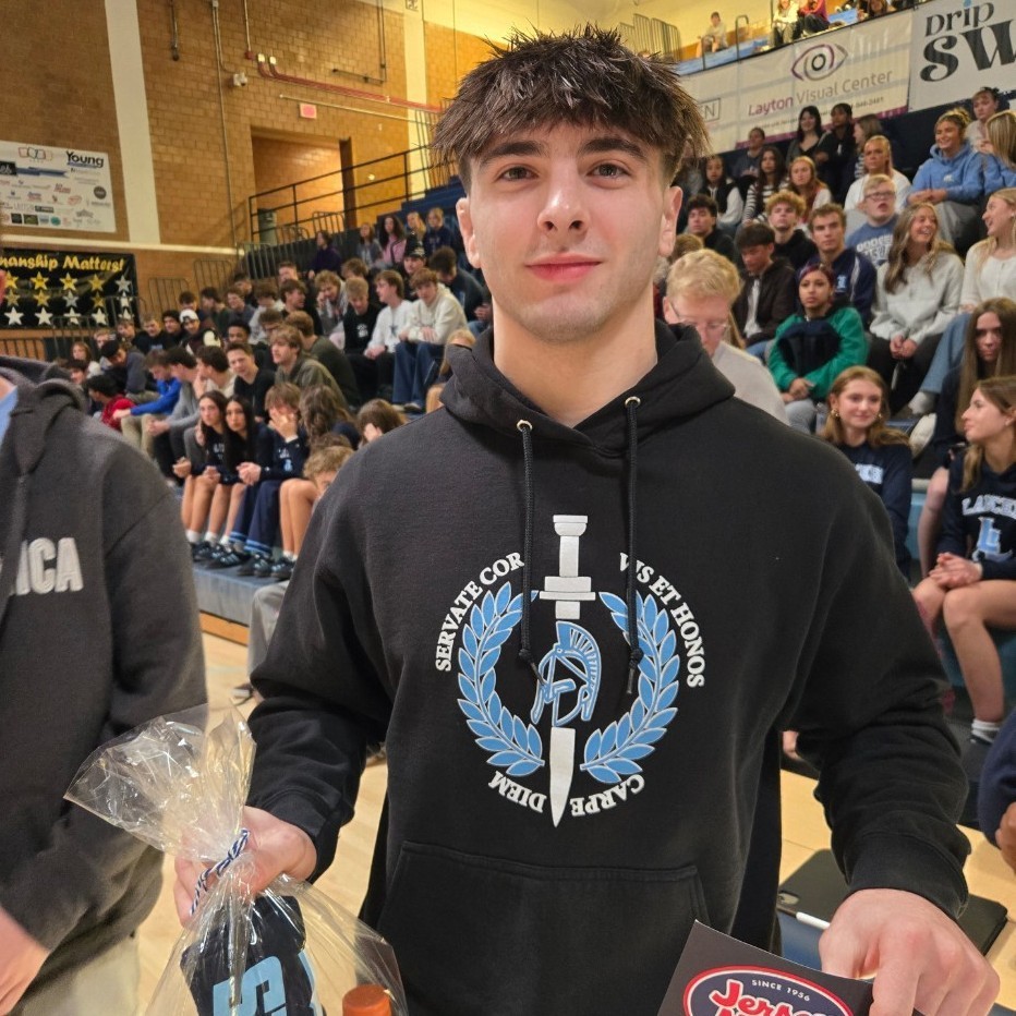 Gavin holding his athlete of the week award