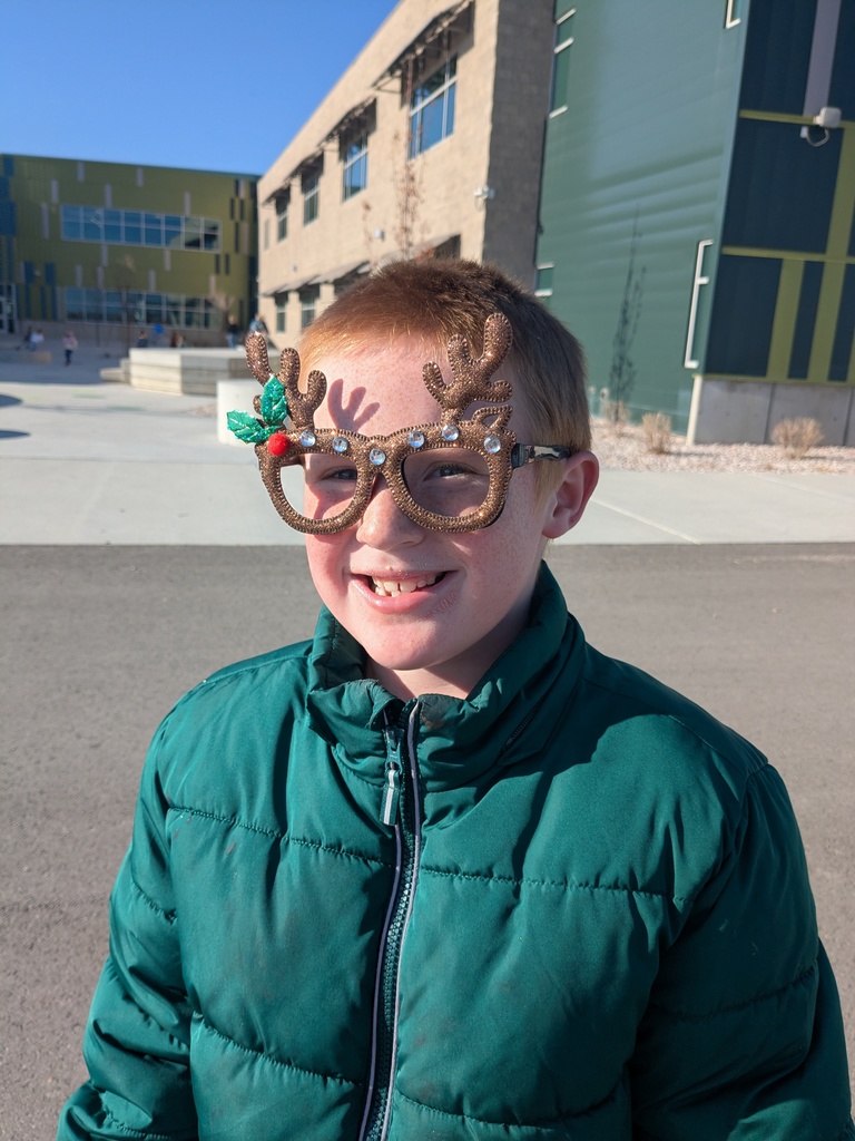 boy with reindeer glasses smiling