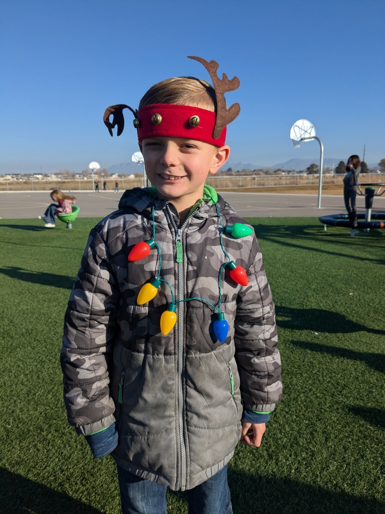 boy with reindeer ears and christmas light necklace