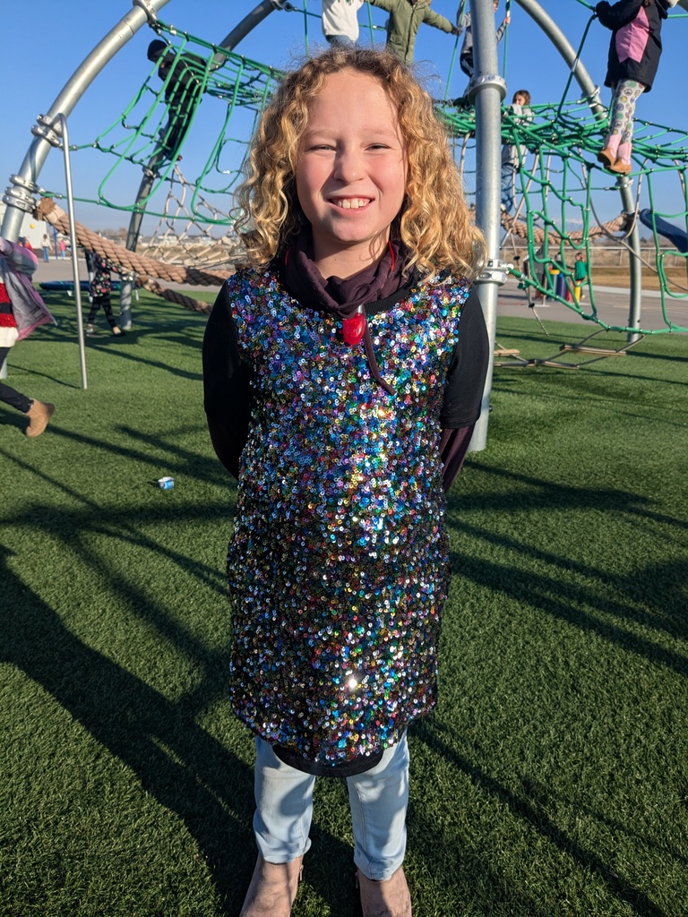 girl with sparkly dress smiling at recess