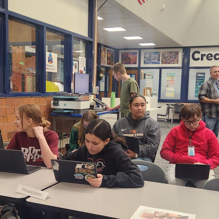 A group of students on their computers at a mock trial event