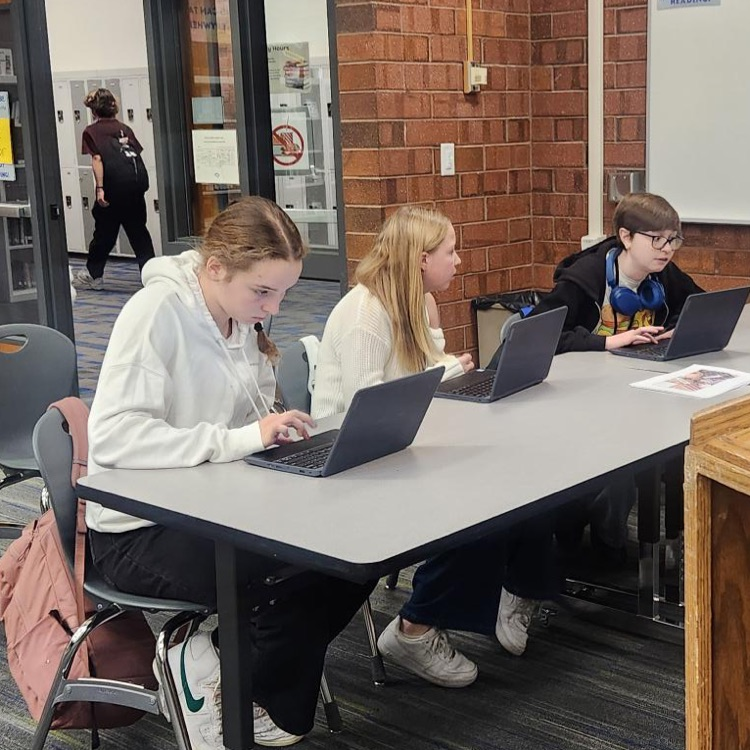 A group of students on their computers at a mock trial event