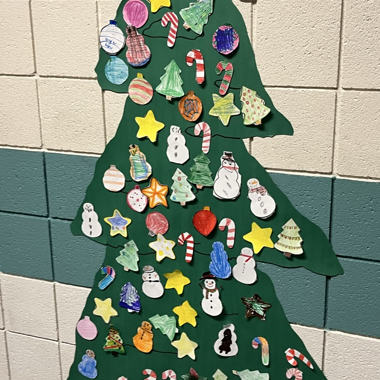 An image is shown displaying a Christmas tree decorated with student made Paper ornaments. 