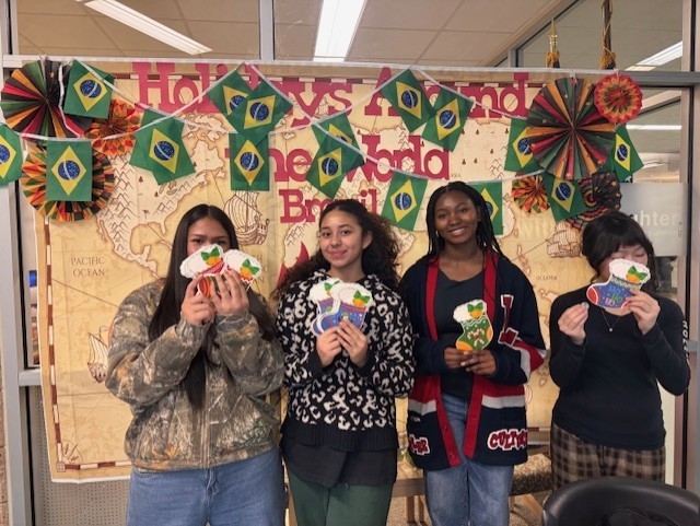 Students are holding stockings that will be hidden throughout the school for others to find.