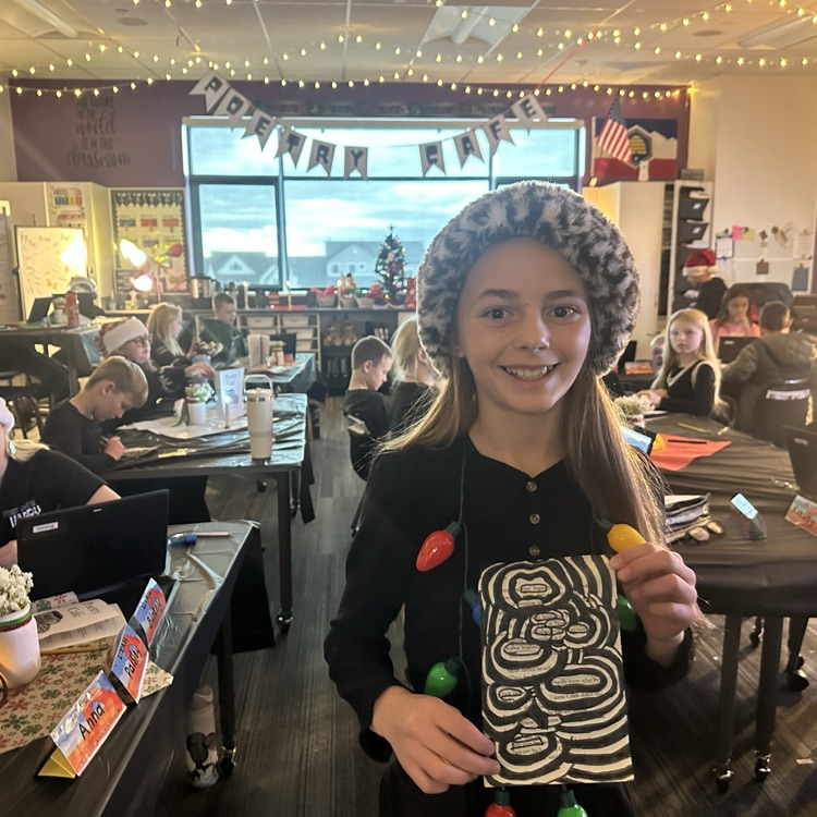 girl holding book page with Santa hat 