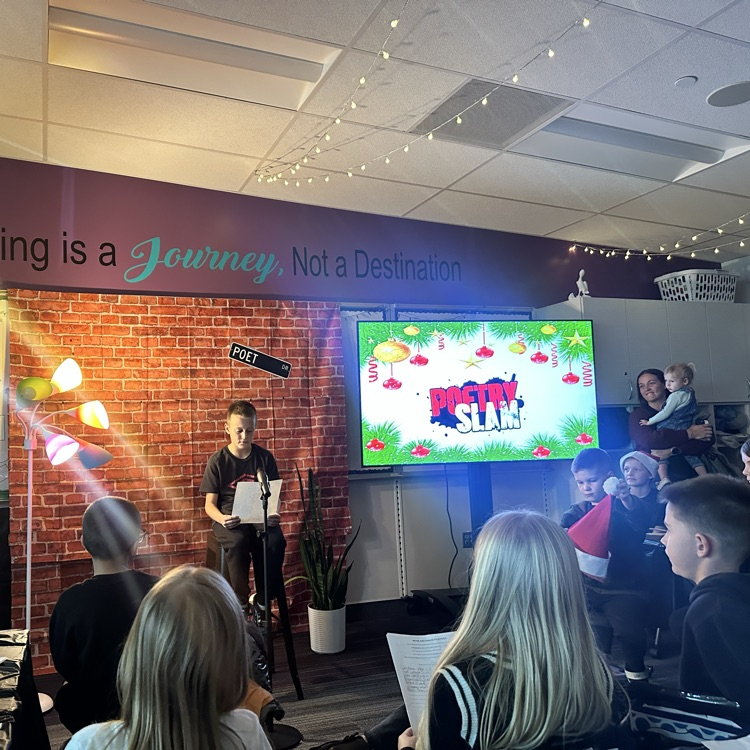 boy presenting in microphone poetry at poetry slam