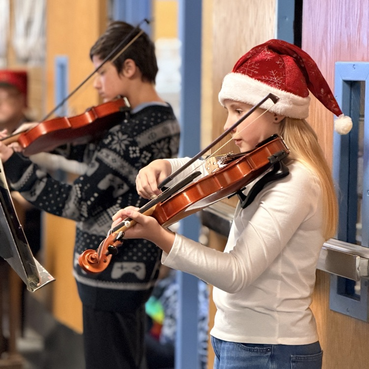 Orchestra students playing music in the hallway!