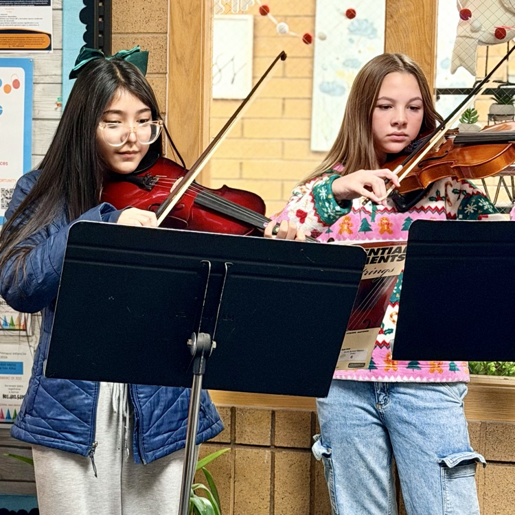 Orchestra students playing music in the hallway!