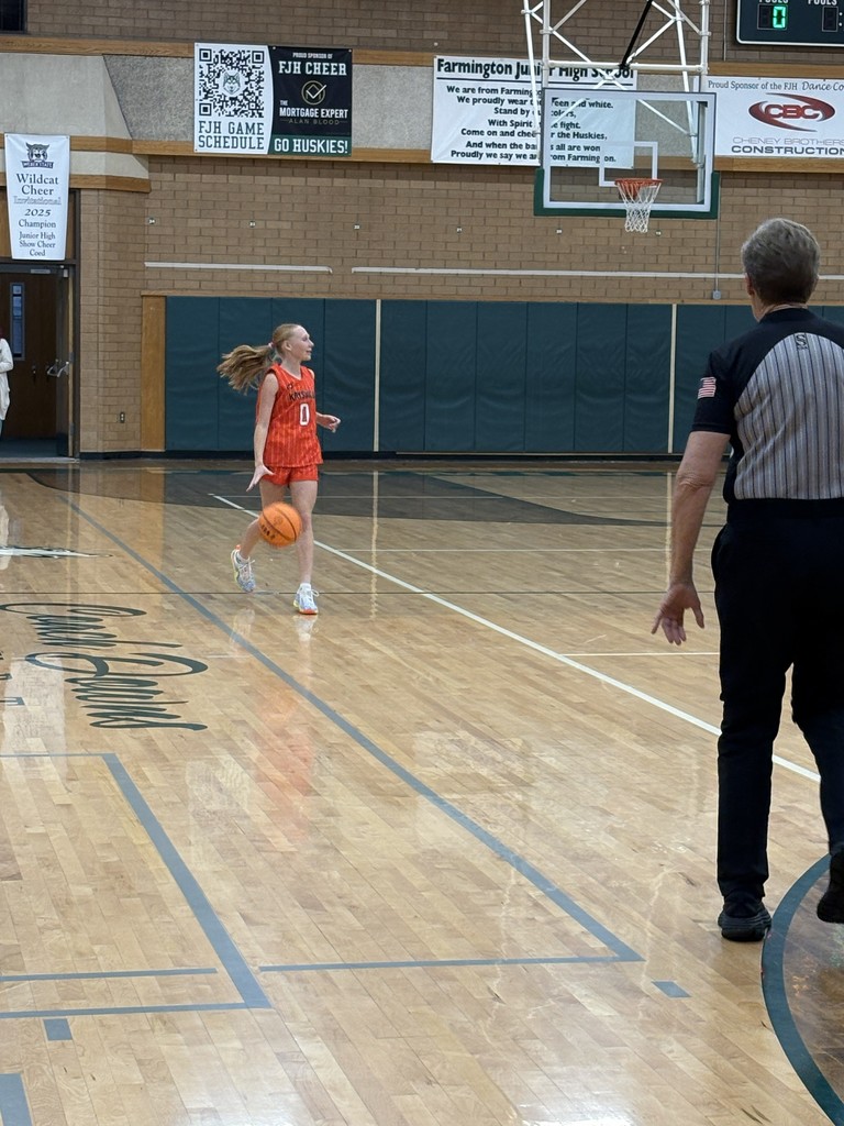 image of girl dribbling a ball down the basketball court