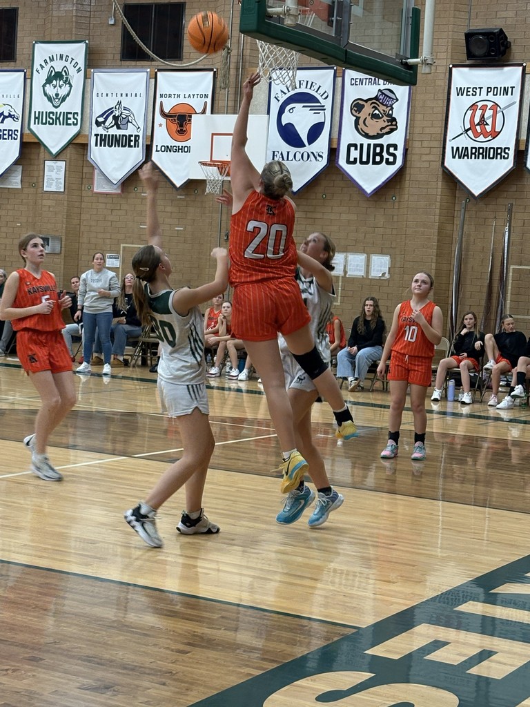 image of a girl doing a layup in basketball