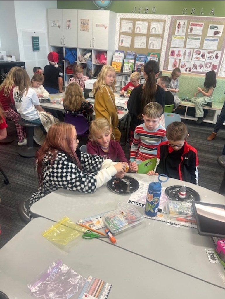 students making snowmen out of clay