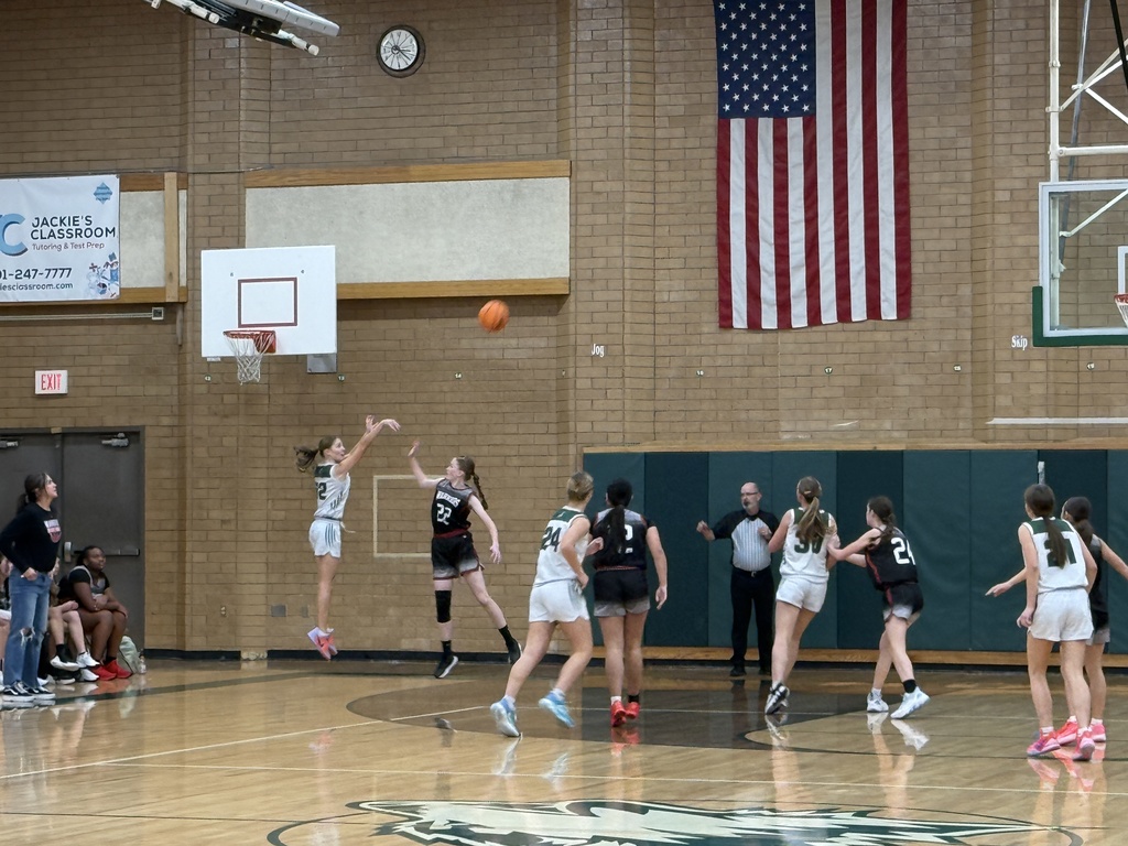 Student shooting a 3 pointer. 