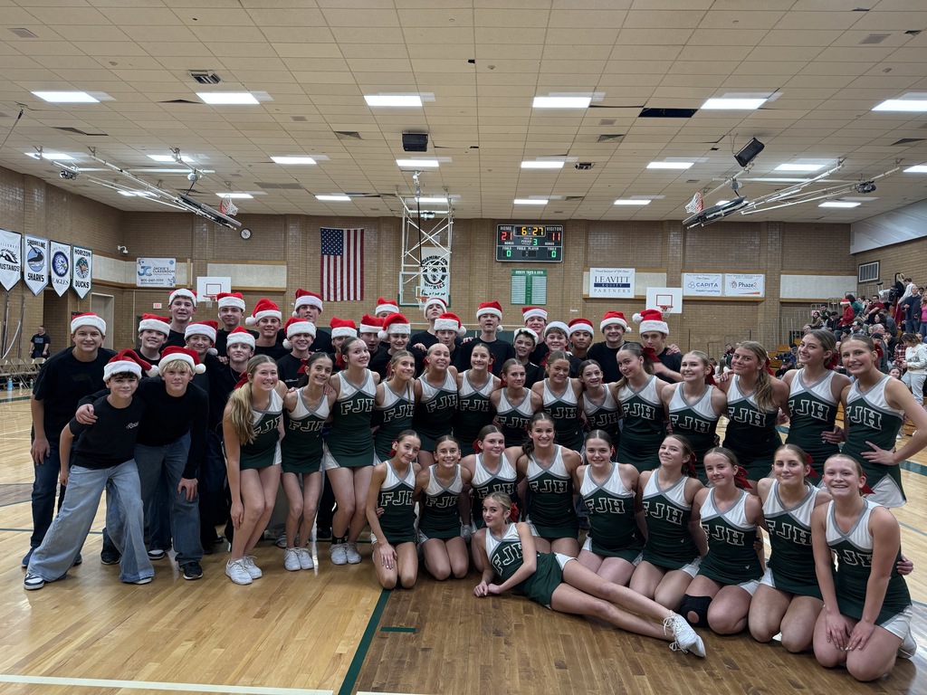 Cheerleaders and cheerleaders-in-training after performing for half time. 