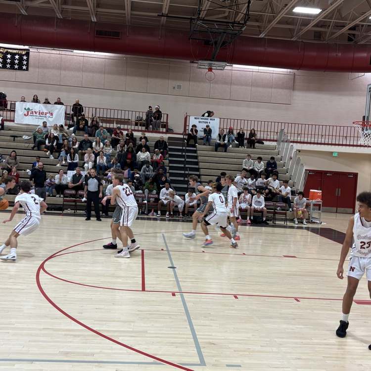 Northridge basketball playing defense