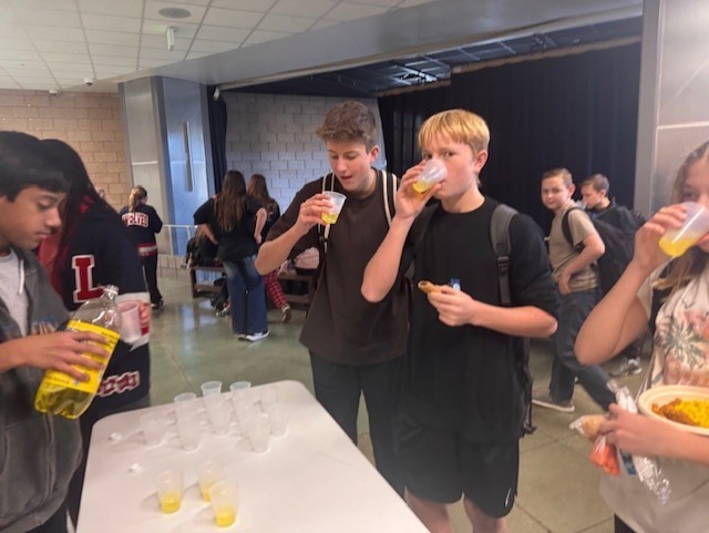 Student enjoy Inca Kola from Peru