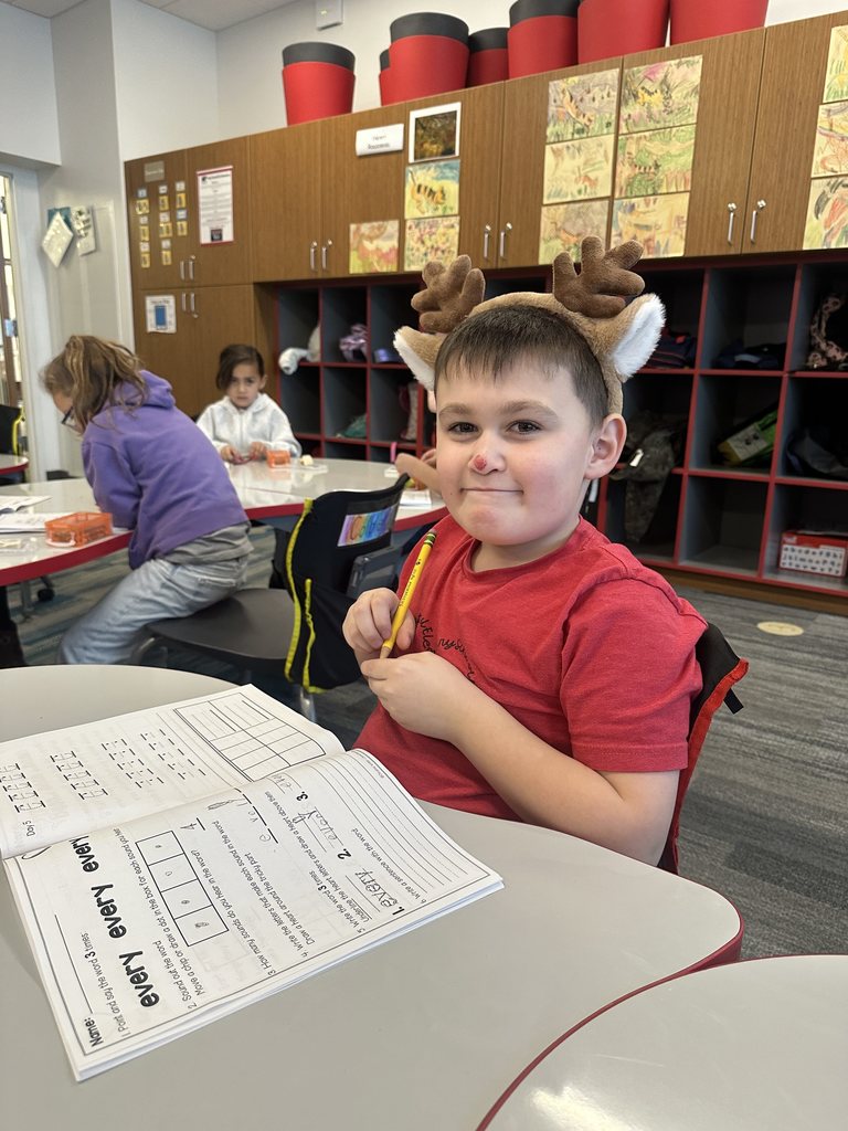 Student wearing reindeer antlers.