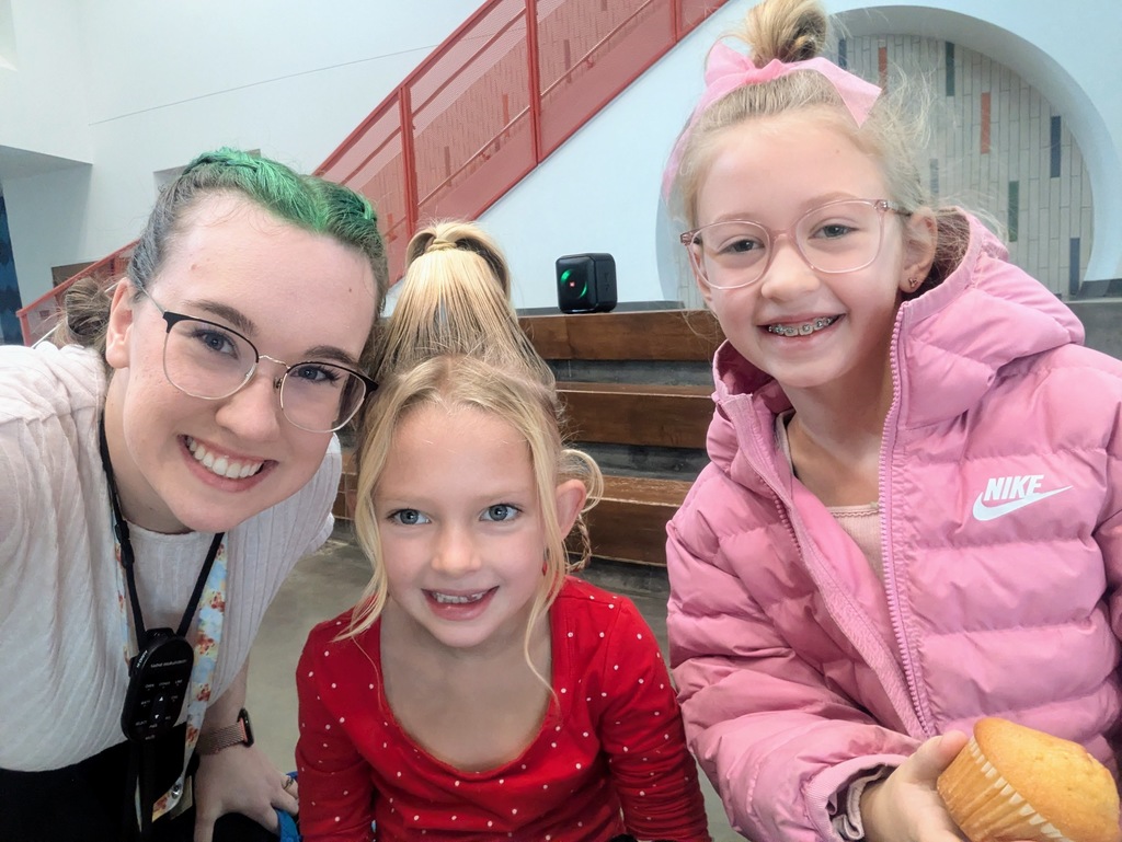 Two students and a teacher with Christmas crazy hair.