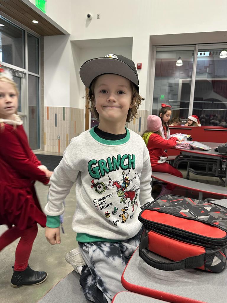 Student dressed in a Grinch shirt.