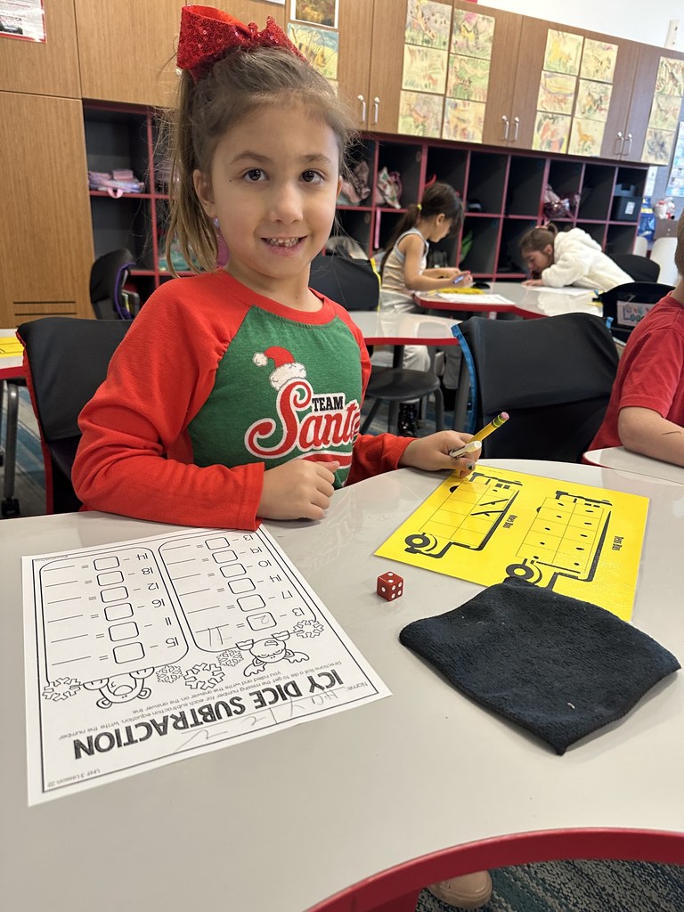 Student working on math wearing Christmas attire.