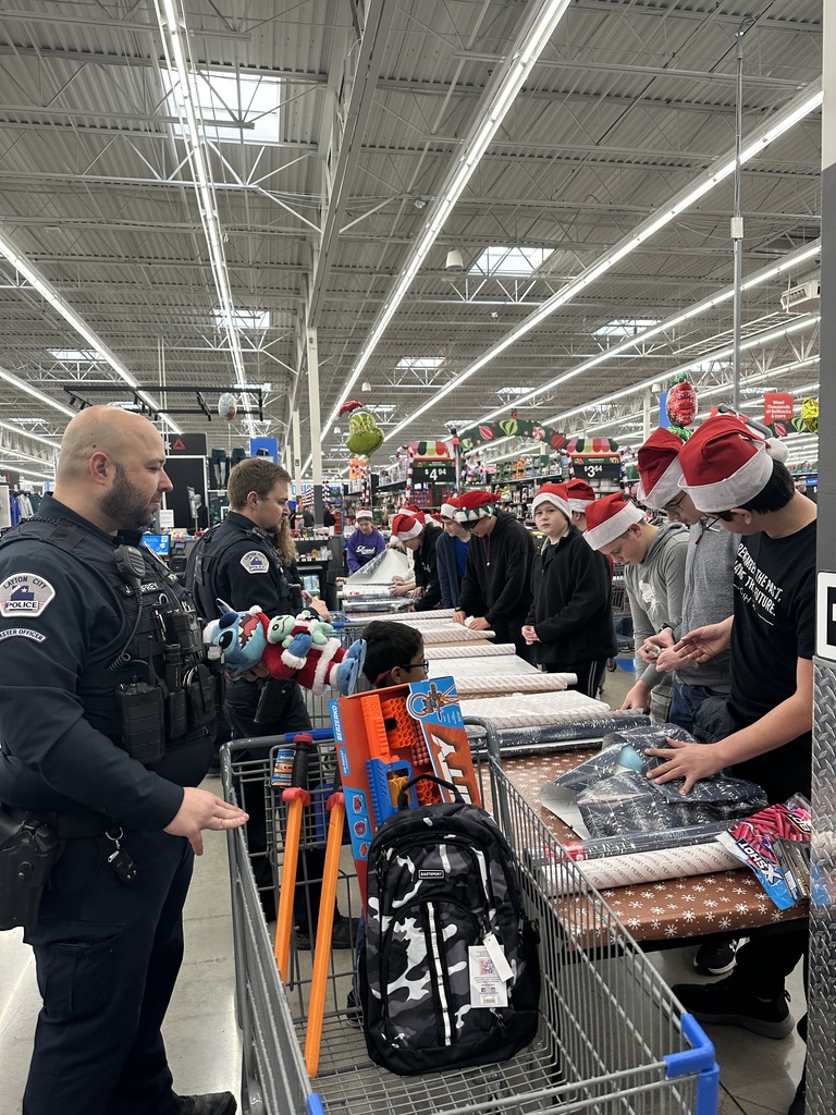 Students and Officers Wrapping Gifts